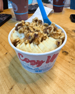 Protein oatmeal bowl topped with bananas and walnuts from Playa Bowls