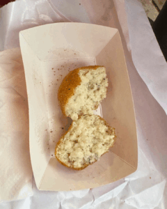 Arancini cut open to show the creamy rice filling inside