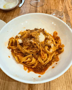Tagliatelle pasta with bolognese sauce and grated cheese at Eataly Flatiron