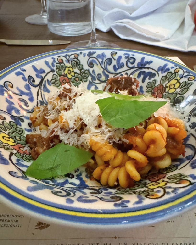 Cavatappi pasta with slow-cooked Neapolitan ragù made with beef, short rib, oxtail, and Parmigiano Reggiano at Amaro Supper Club.