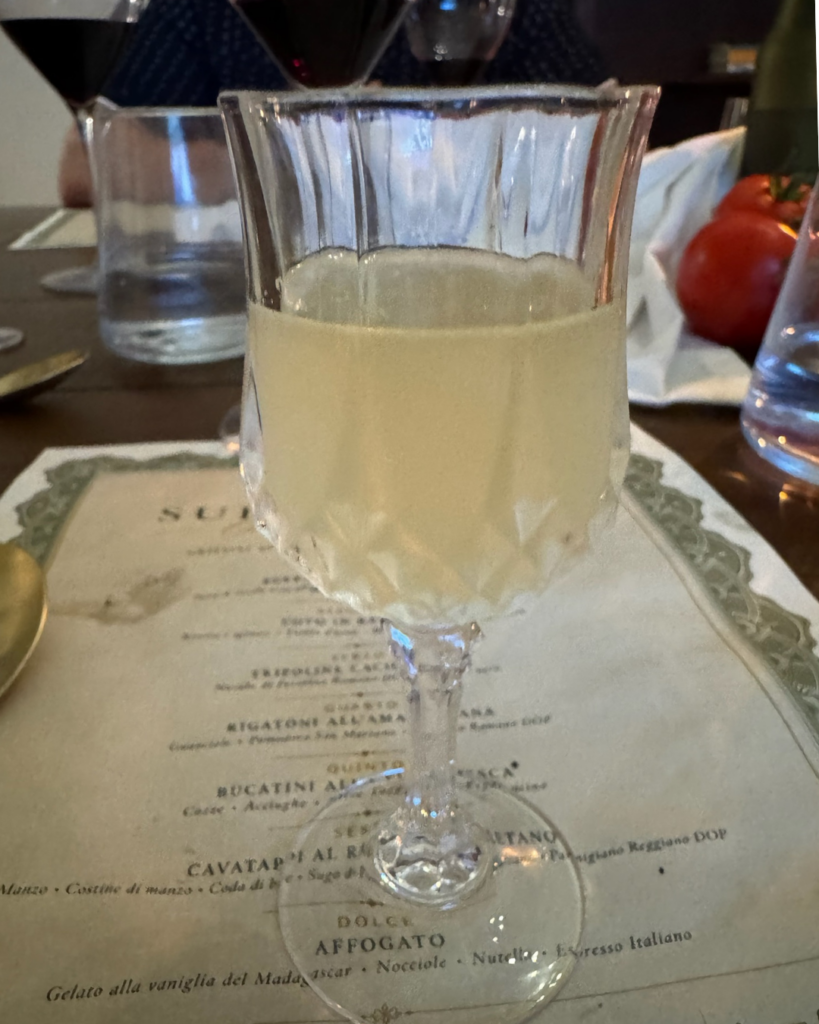 Housemade limoncello served in a stemmed glass as a refreshing palate cleanser during the Italian omakase experience at Amaro Supper Club in Fairhope, Alabama.